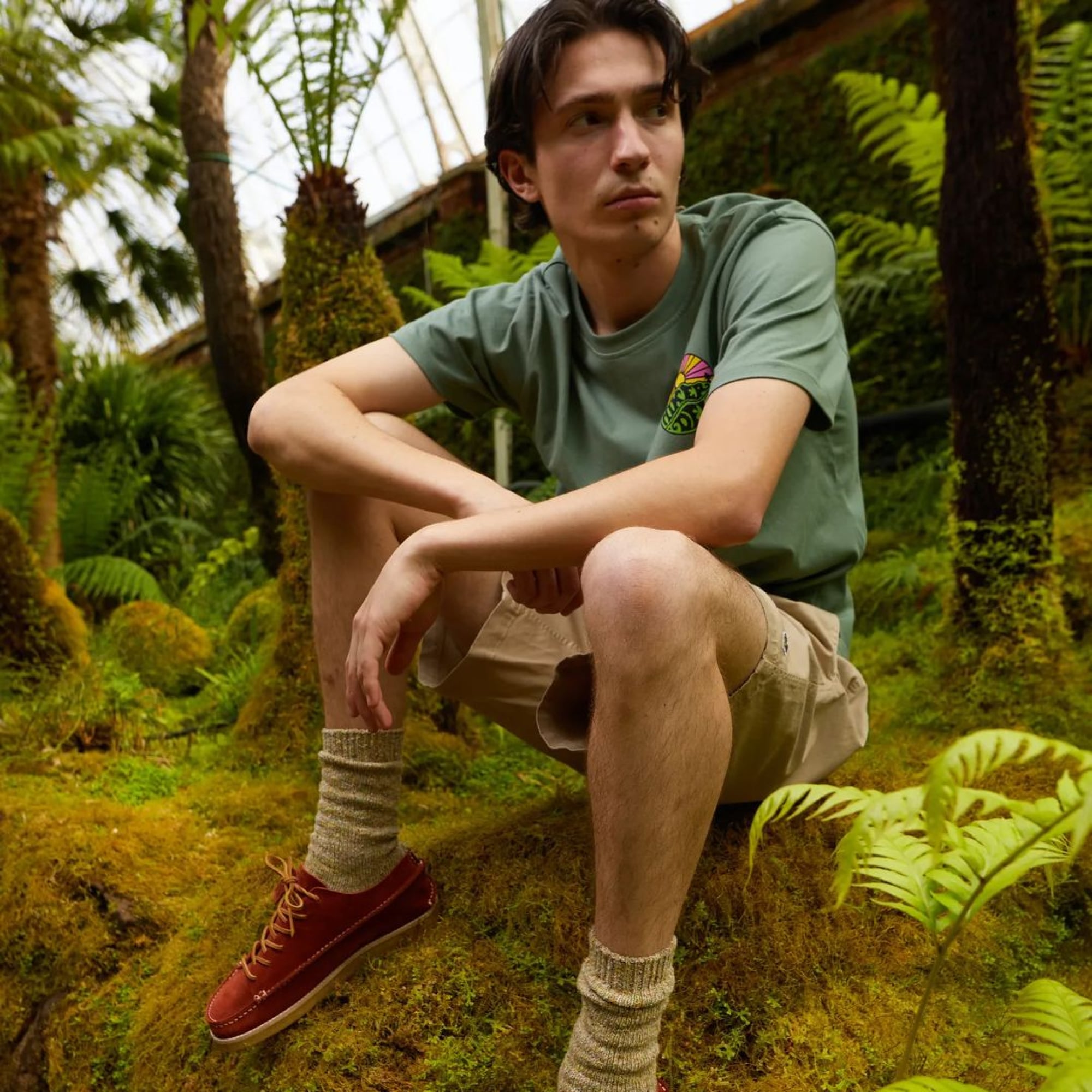 A guy sit outside on a rock with pants and shirt from Hikerdelic
