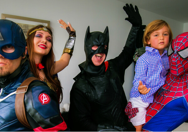 Captain America, Wonder Woman, Batman, and Spiderman entertaining a boy at his birthday party