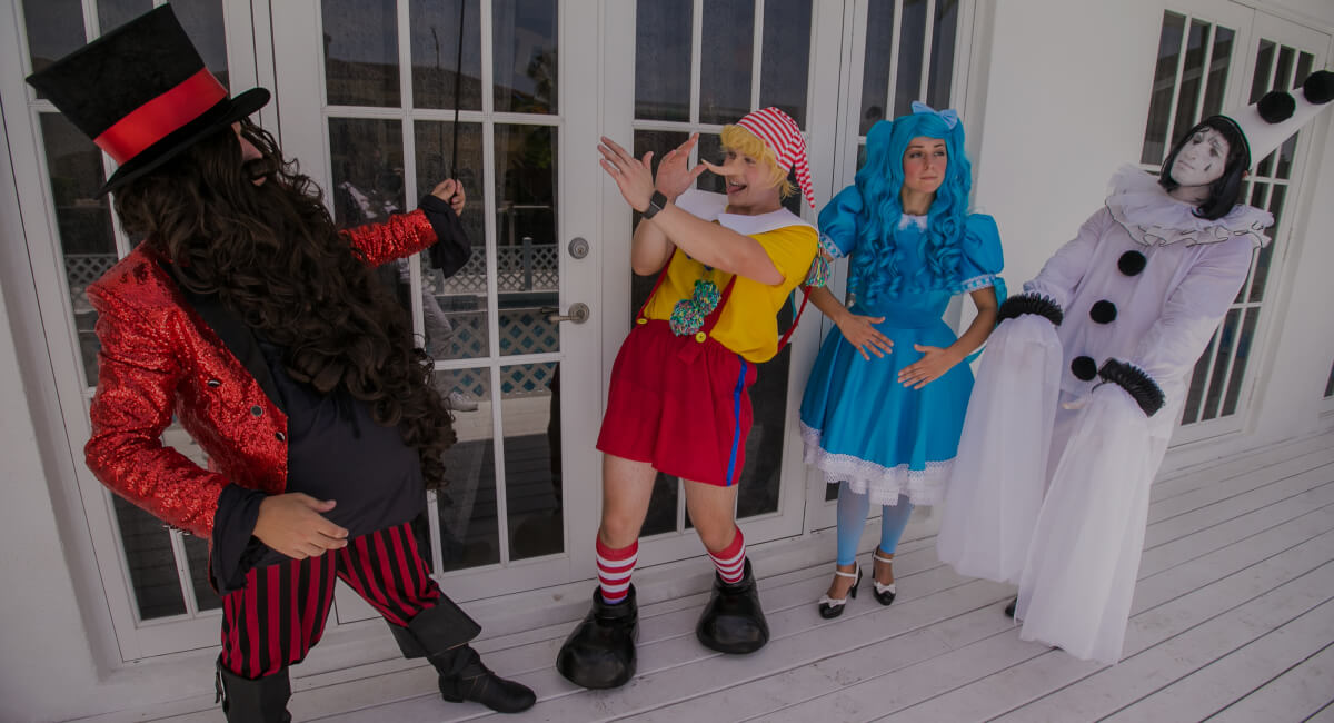 Pinocchio mocking Karabas Barabas while Malvina and Pierrot stand behind him — Pinocchio party