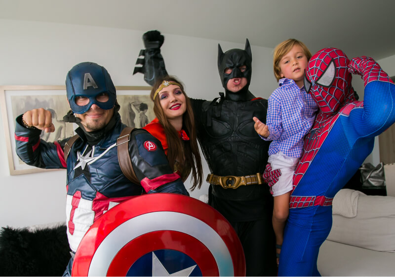 Captain America, Wonder Woman, Batman, and Spiderman entertaining a boy at his birthday party