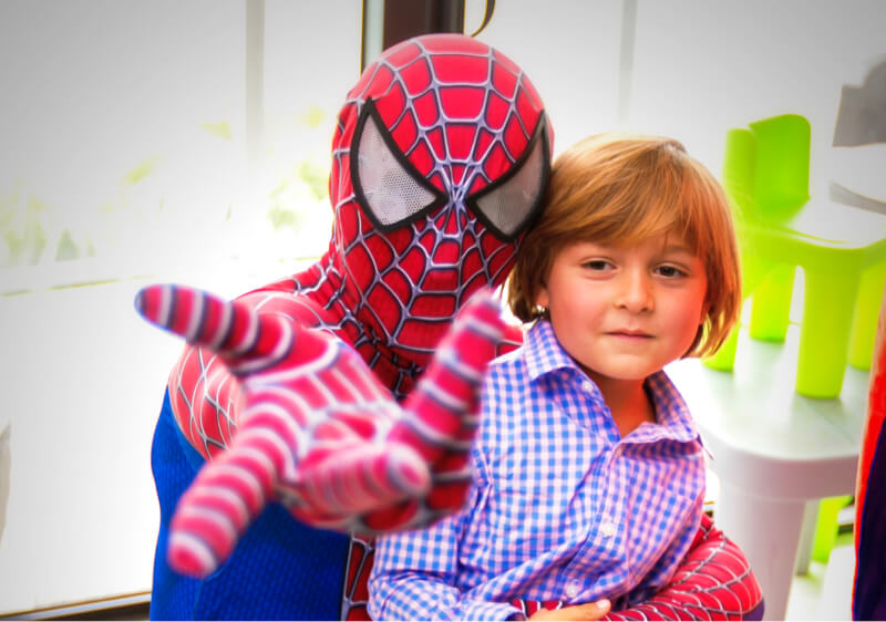 Spiderman saving a baby and shooting out web out of his hand 