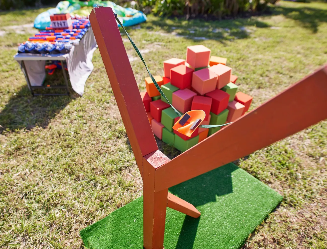 A closeup photo of a slingshot and foam cubes