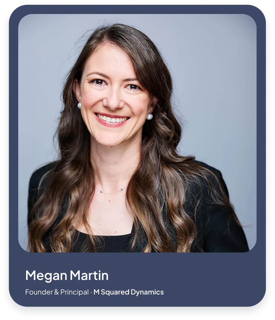 Portrait of Megan Martin smiling, with long brown hair, wearing pearl earrings and a black top.