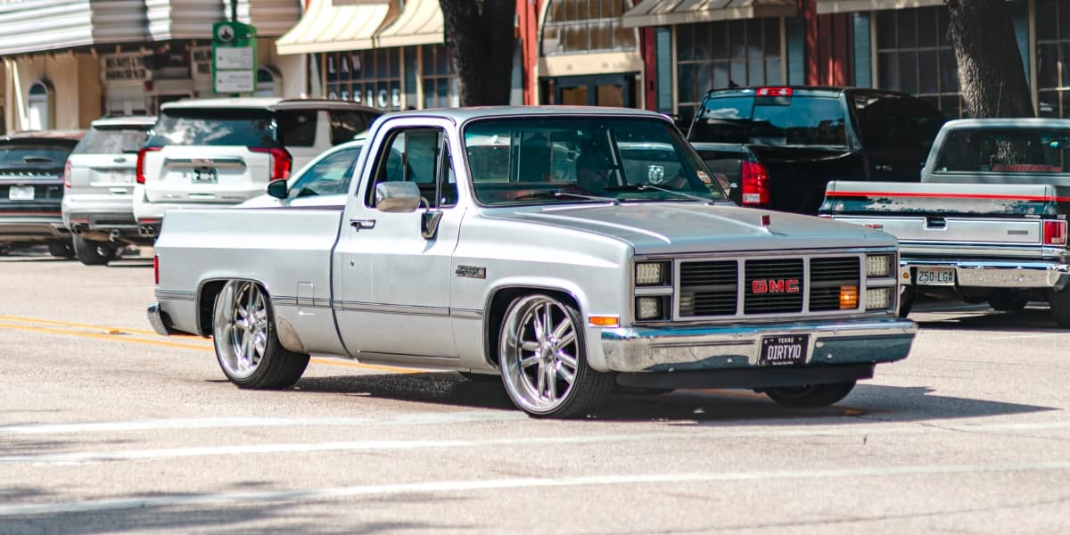 Classic pickup truck parked among trucks on a street in Texas