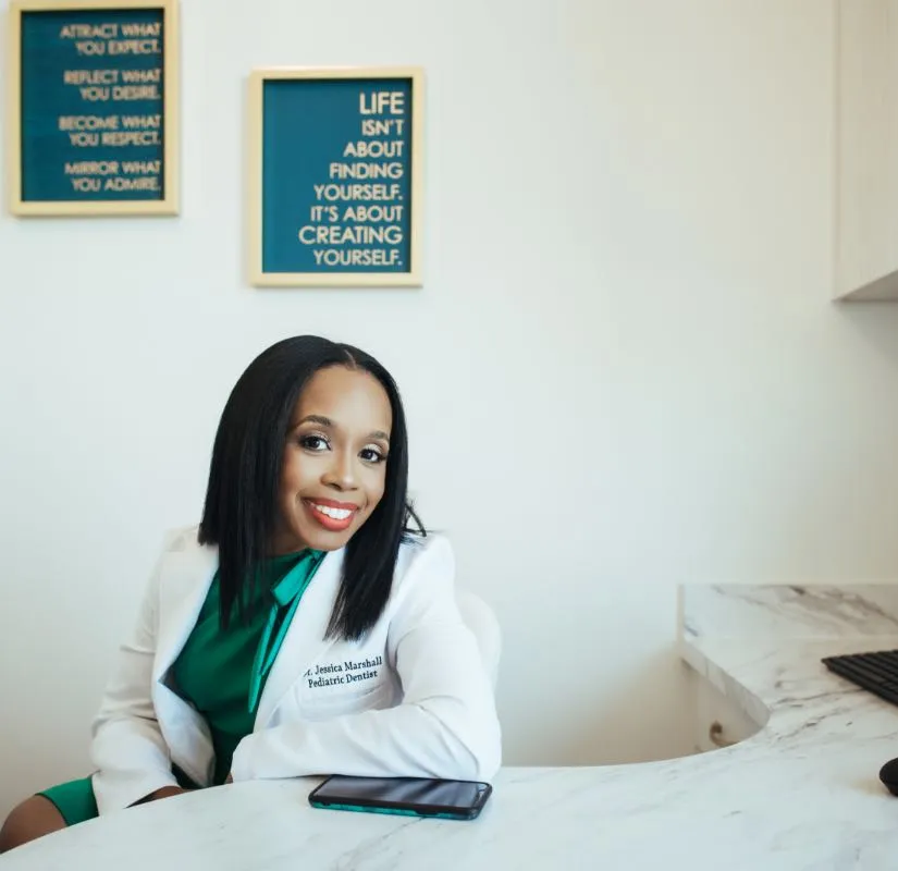 Photo of pediatric dentist Jessica Marshall sitting behind her desk