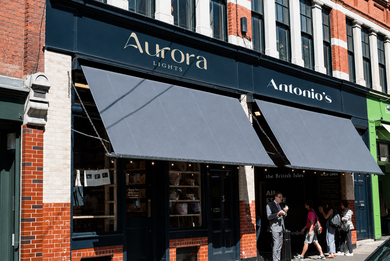 Aurora storefront in London with a navy fascia, grey awnings and people on the sidewalk