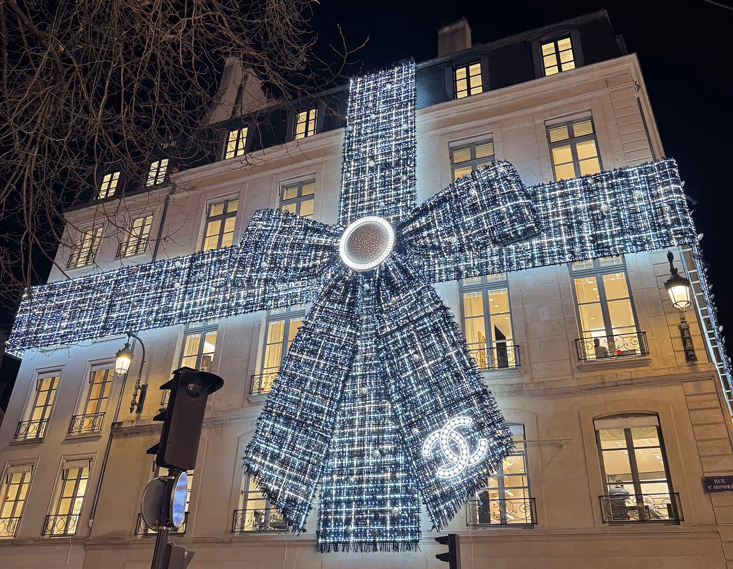 Christmas wrapping paper and bow in tweed around a parisian bulding - Chanel logo