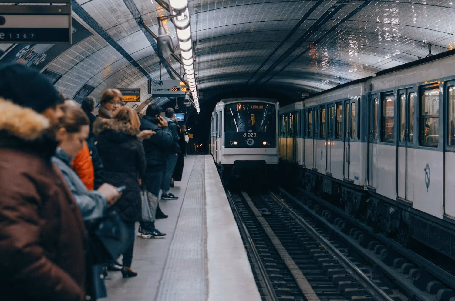 Peolpe waiting for the metro on the platform in Paris