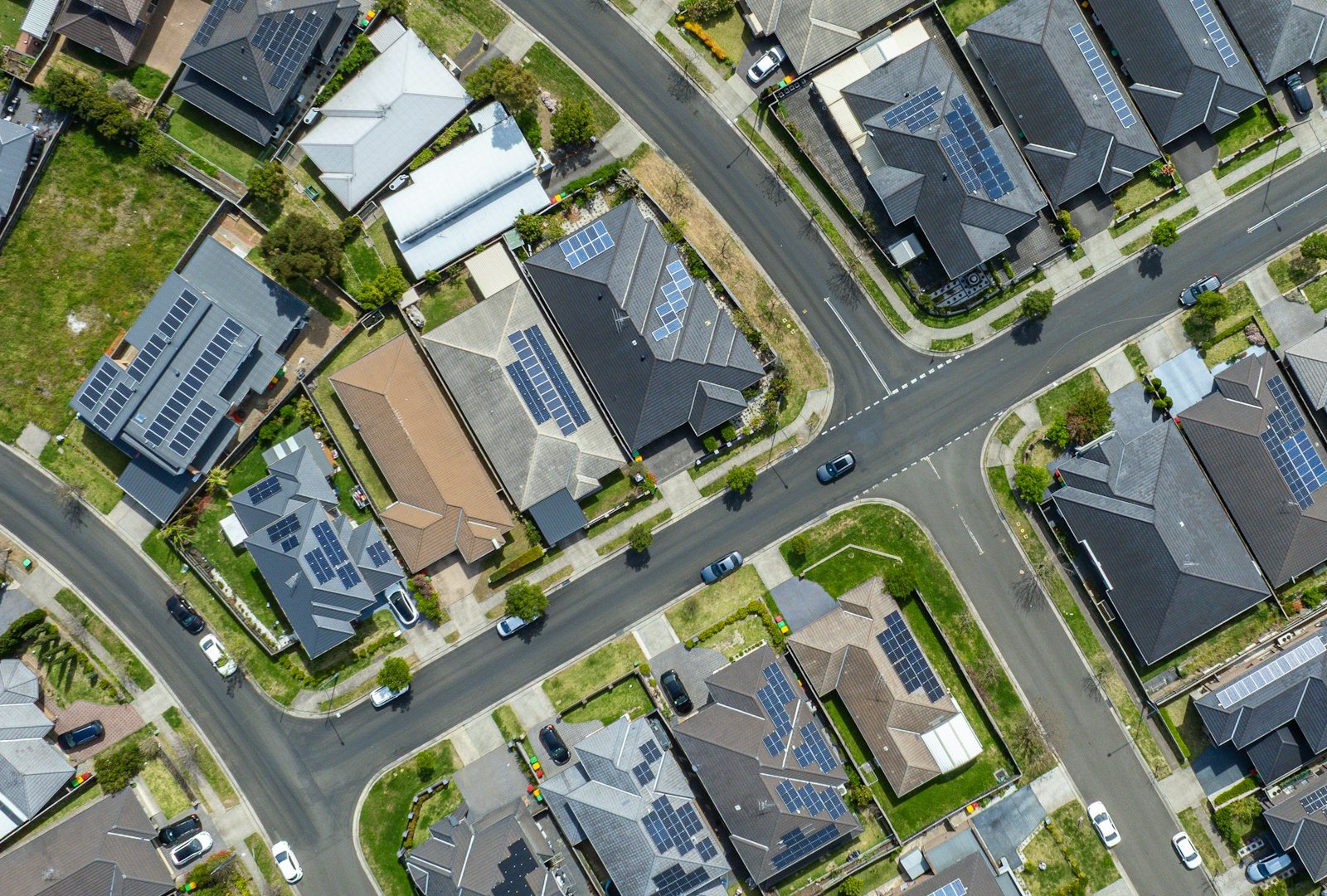 An aerial view of a suburban neighbourhood with solar panels on many rooftops