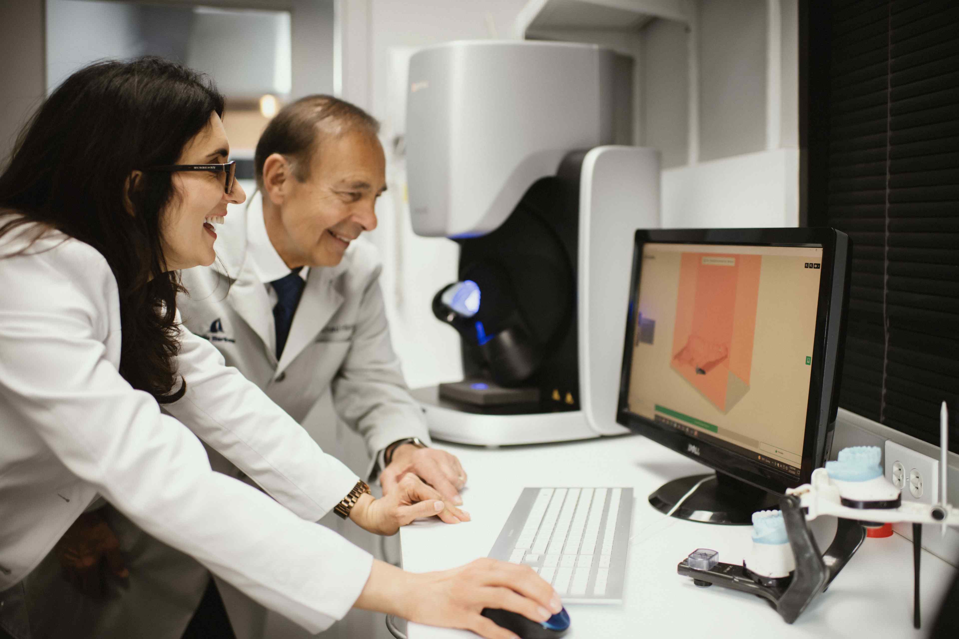 Dr. Rad and Dr. Hlista working together on the computer