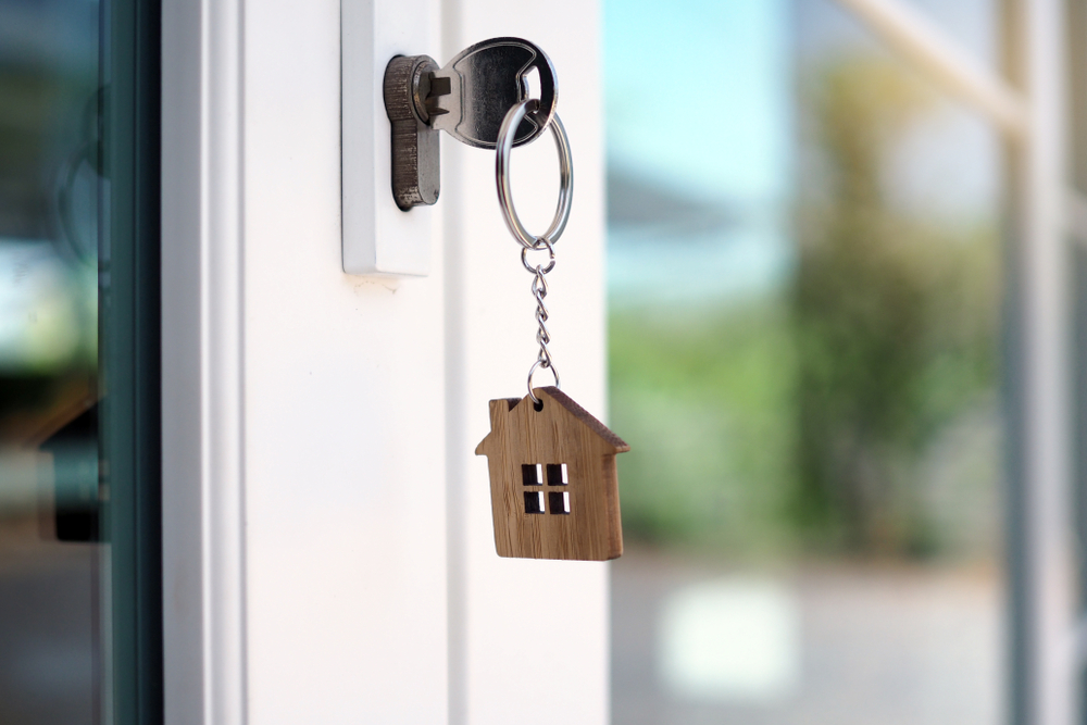 Keys in door with house 