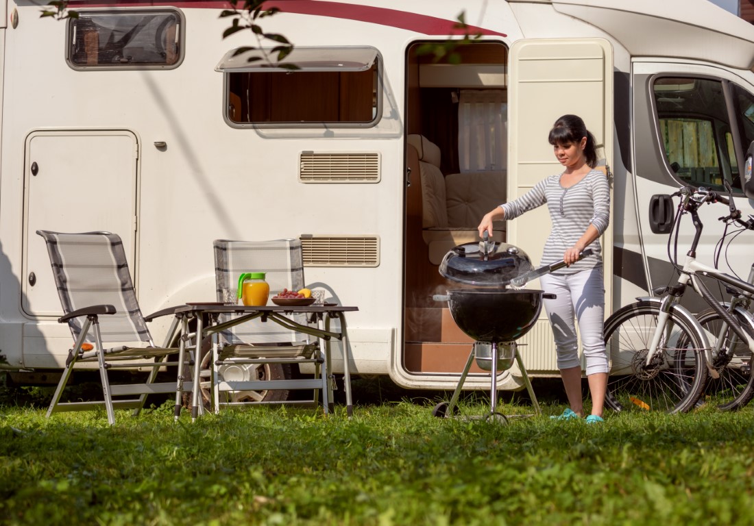 Family vacation travel RV, holiday trip in motorhome, Caravan car Vacation. Picnic with outdoor barbecue.