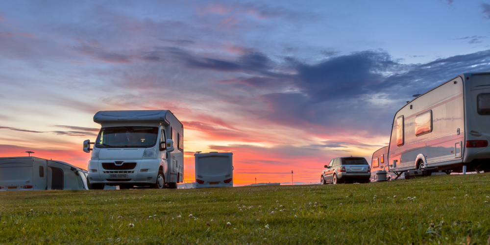 Motorhome and touring caravans in a park