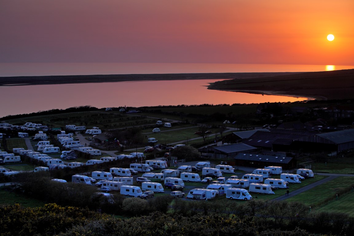 Sun setting over coastal caravan park in Dorset England