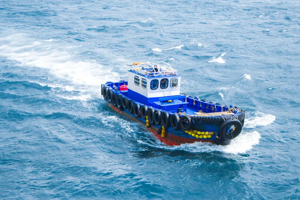 Large blue fast fisher boat out on the ocean
