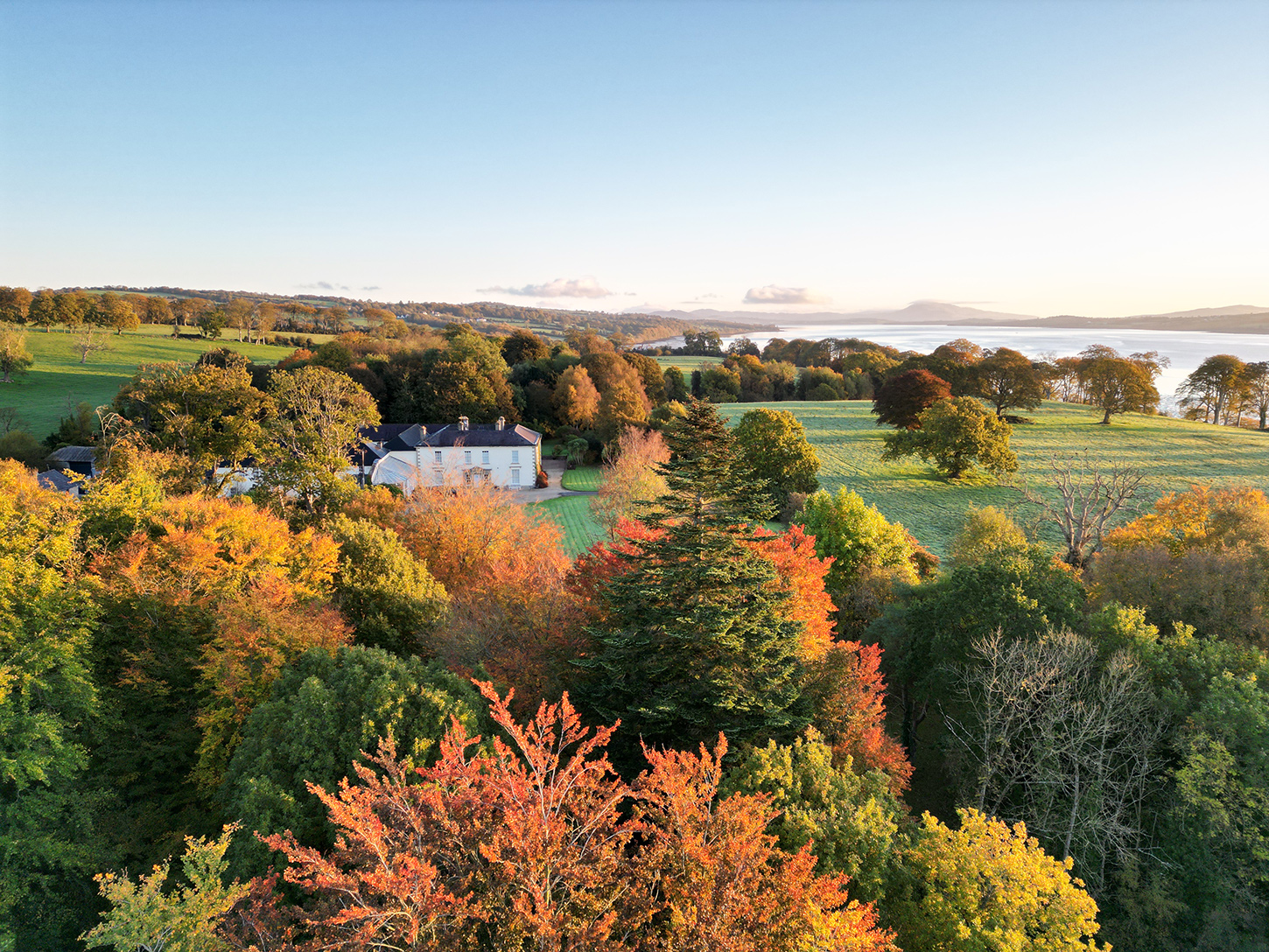 Castle Grove main house, featuring Georgian architecture and surrounded by lush gardens, embodies historic luxury and Irish charm