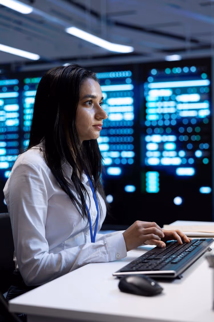 Woman performing real time monitoring at a command center.