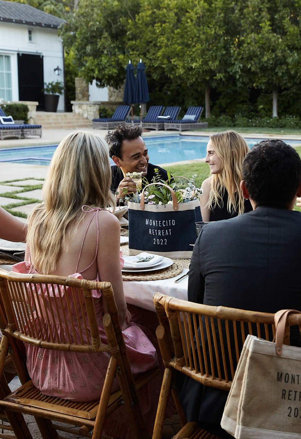 People celebrating at an event with a customized market sitting at the center of the table