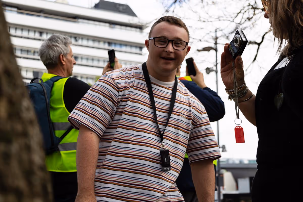 A man smiling while doing a photography course
