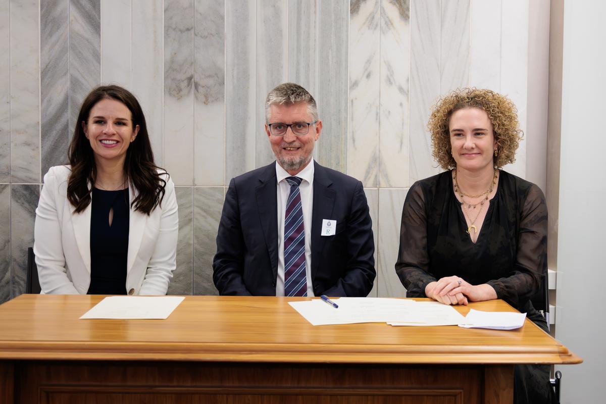 Hon Erica Stanford, Andrew Crisp and Ellen MacGregor Reid signing the settlement at parliament.