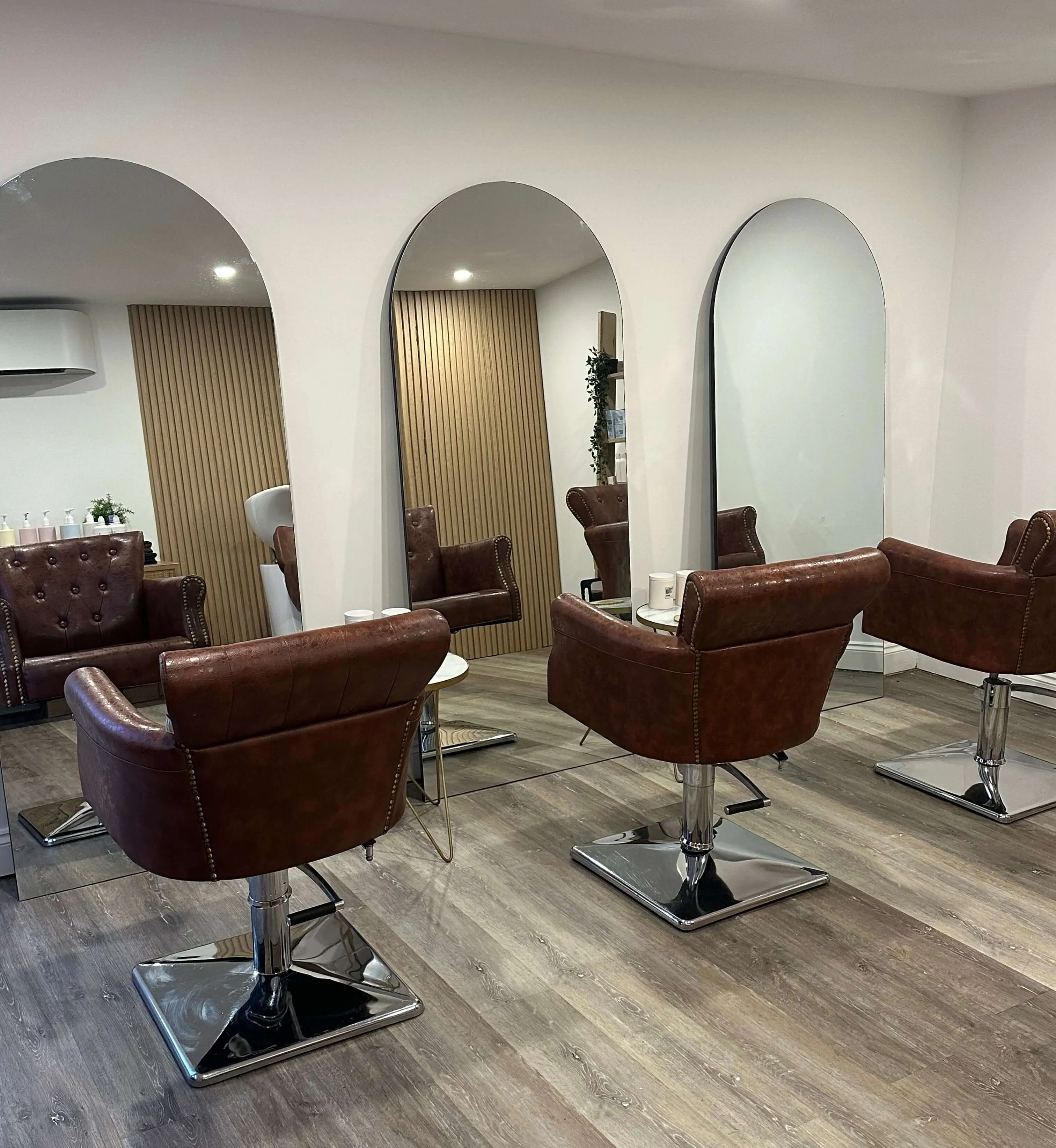 Coffee table at AB Hair Design Salon with a hair dryer and lamp on it.