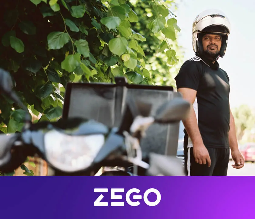 A Delivery Man Standing behind his Scooter