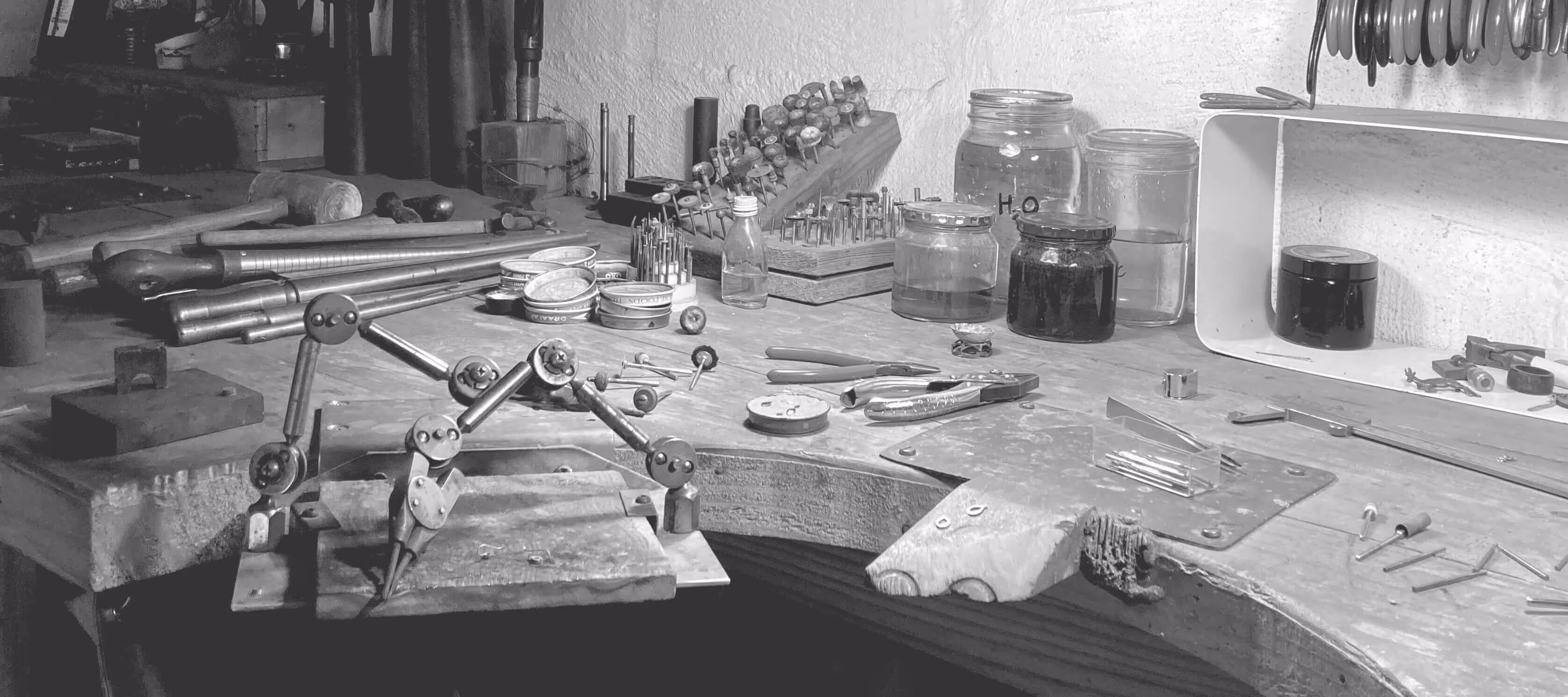 black and white image of a jeweller's workbench