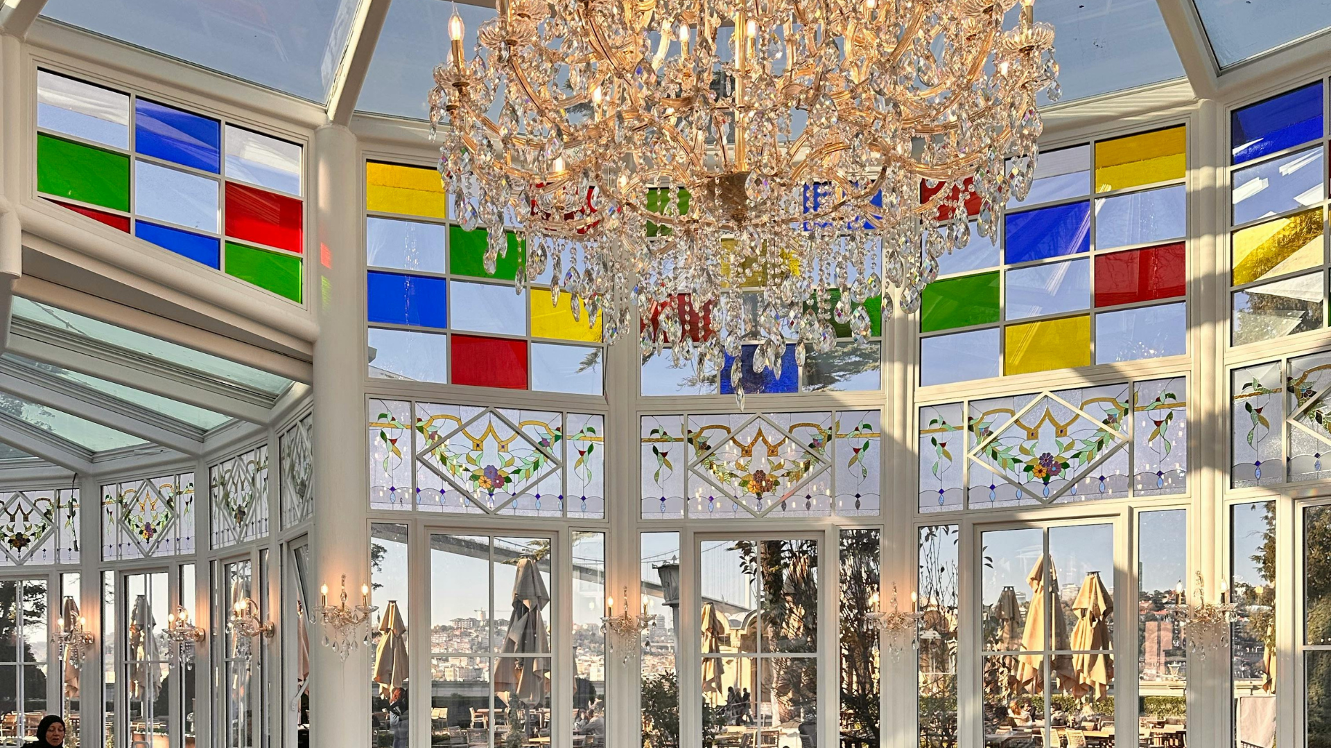 Brightly coloured stained-glass panels in an atrium of a restaurant.