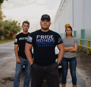 A man wearing a Pride, Bravery, Honor t shirt
