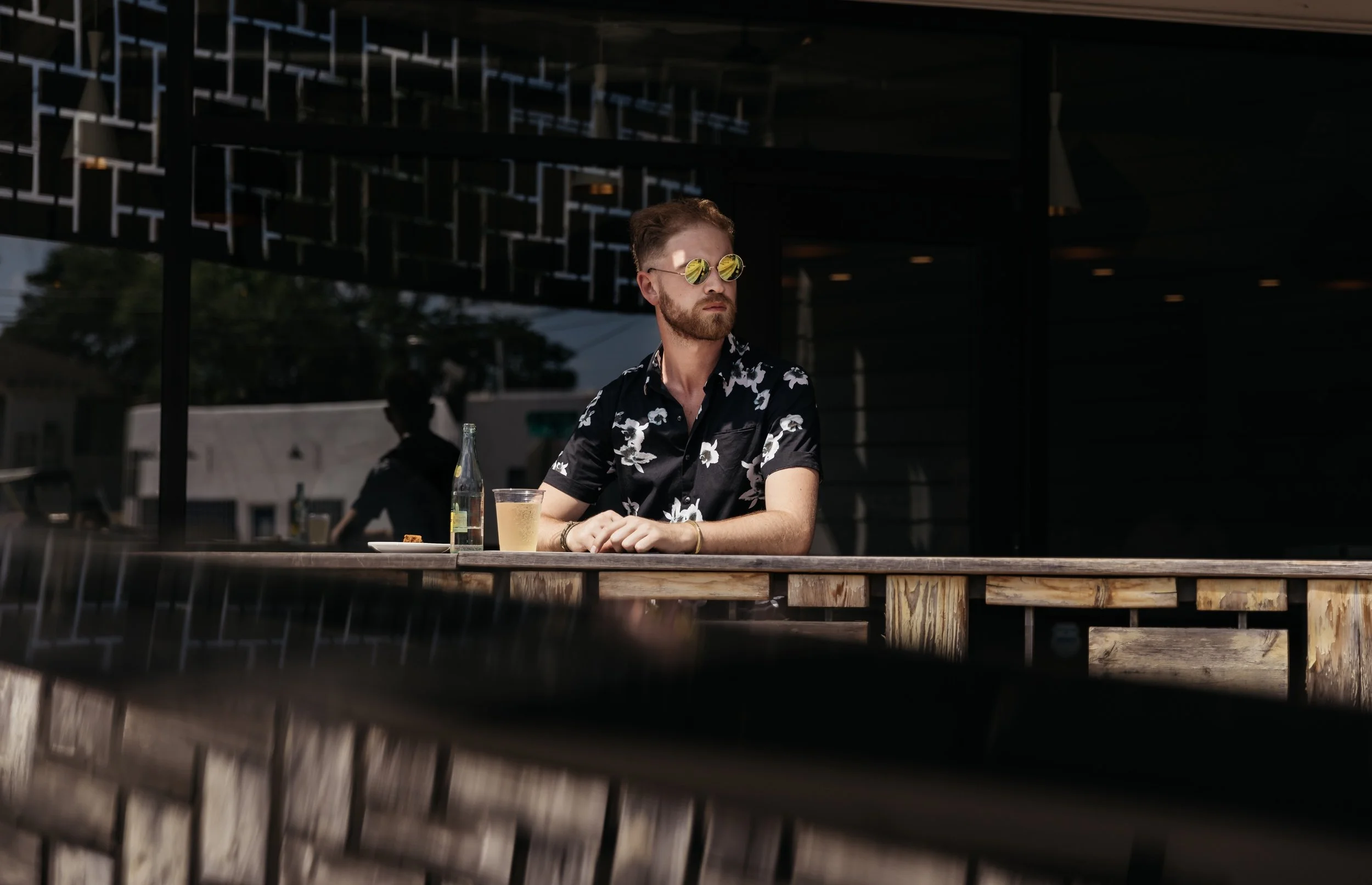 Paul Tellefsen, coo of Labyrinth Brand Co, seated casually in a black shirt and sunglasses for a self portrait.