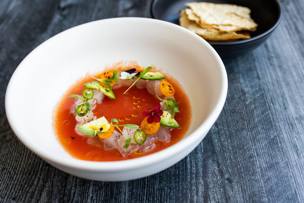 Our popular fish ceviche appetizer. Marinated white fresh fish on a tomato lime juice