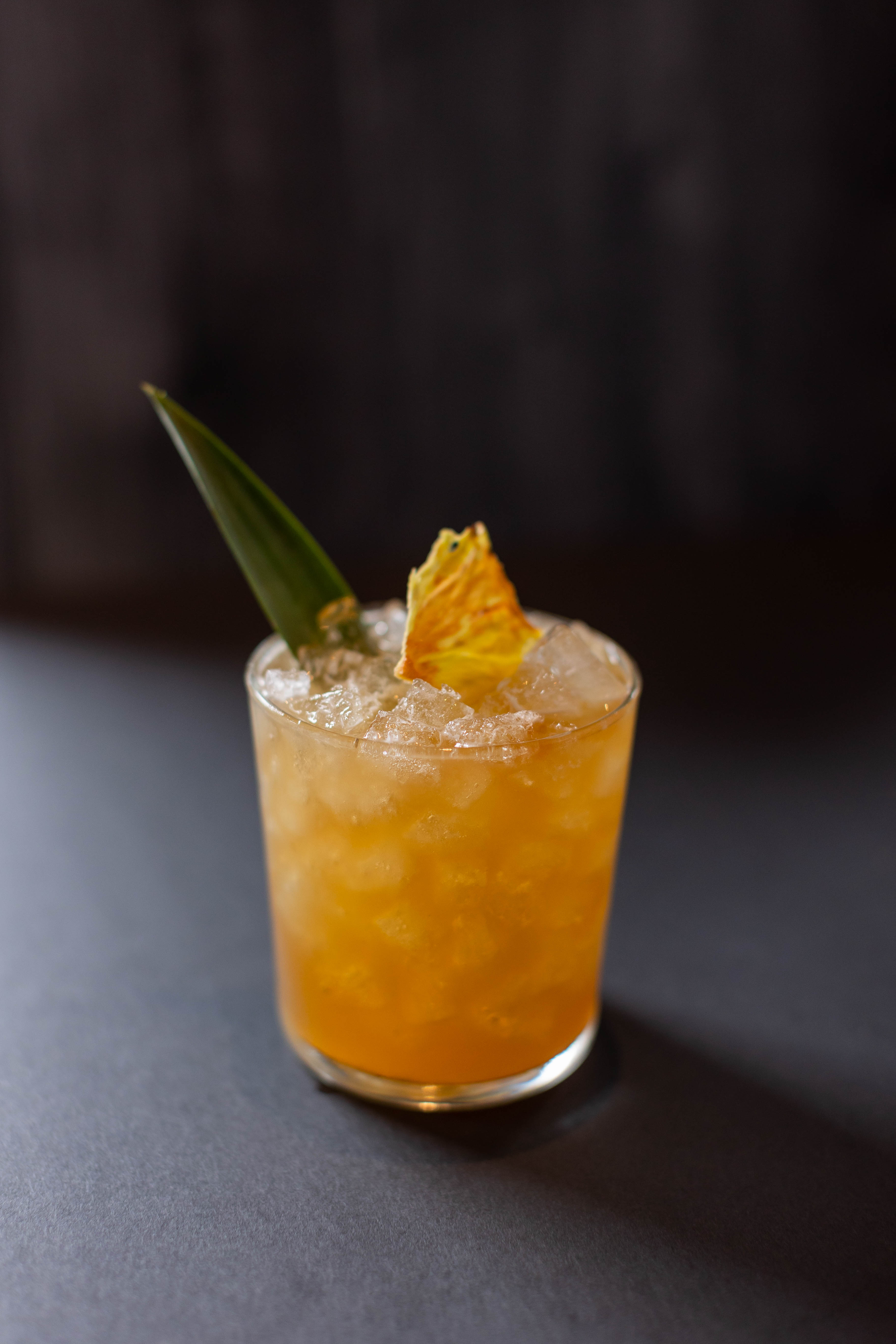 Signagutre cocktail named Aged of Aquarius. Prepared with mezcal and citrus juices