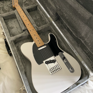 Newest guitar.  A white Fender Telecaster with a black pickguard and maple neck.