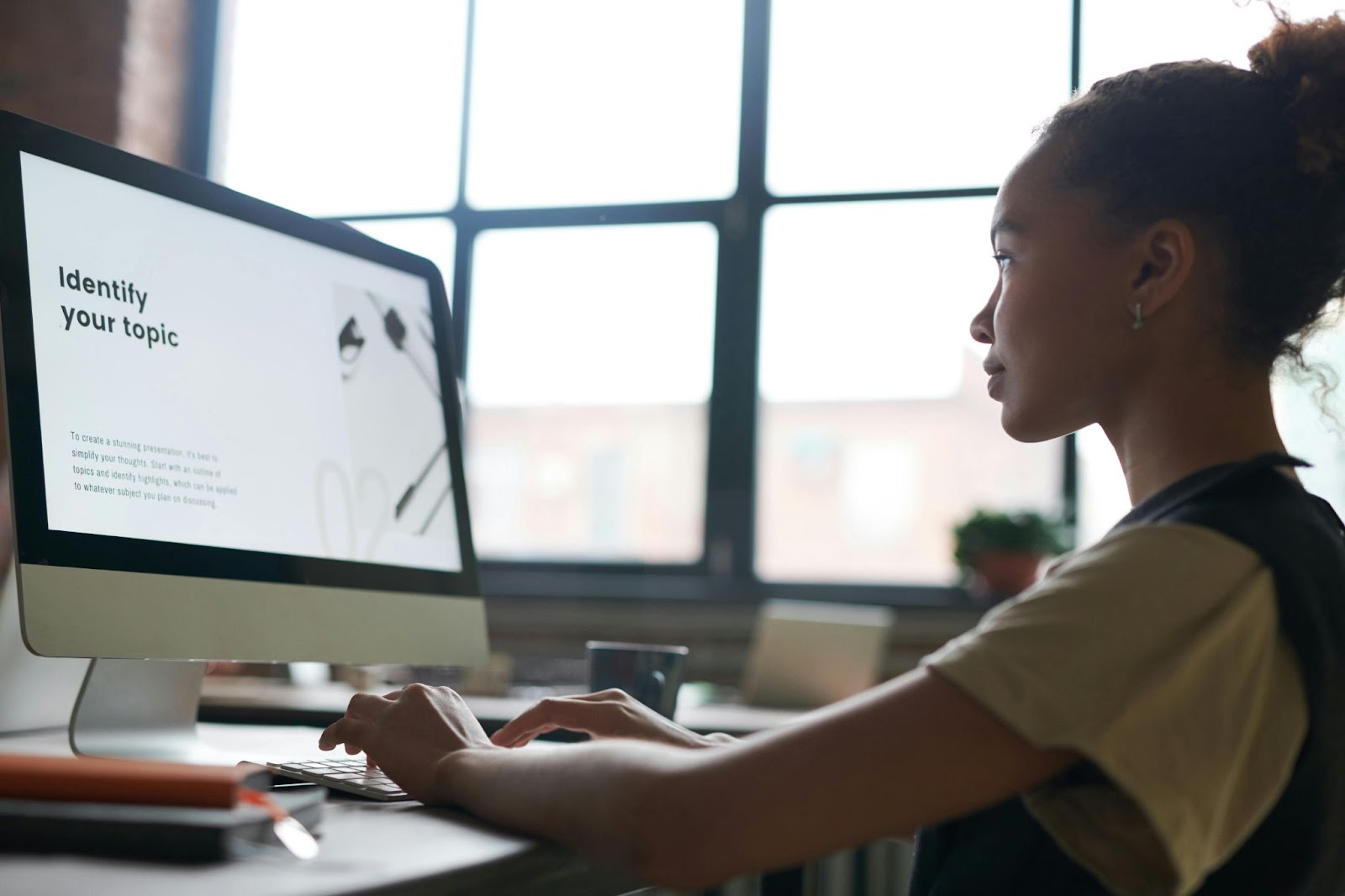 A student works through a slideshow on a desktop computer.