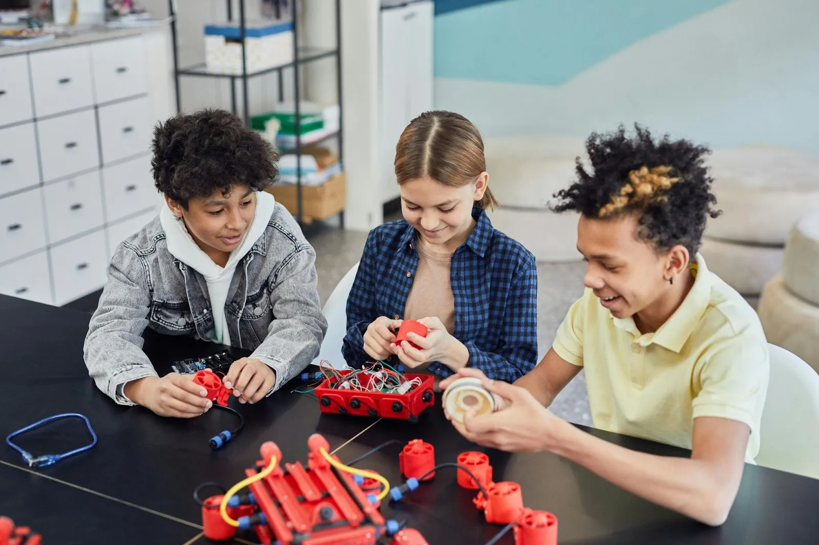 A group of three students works together on a STEM project. 