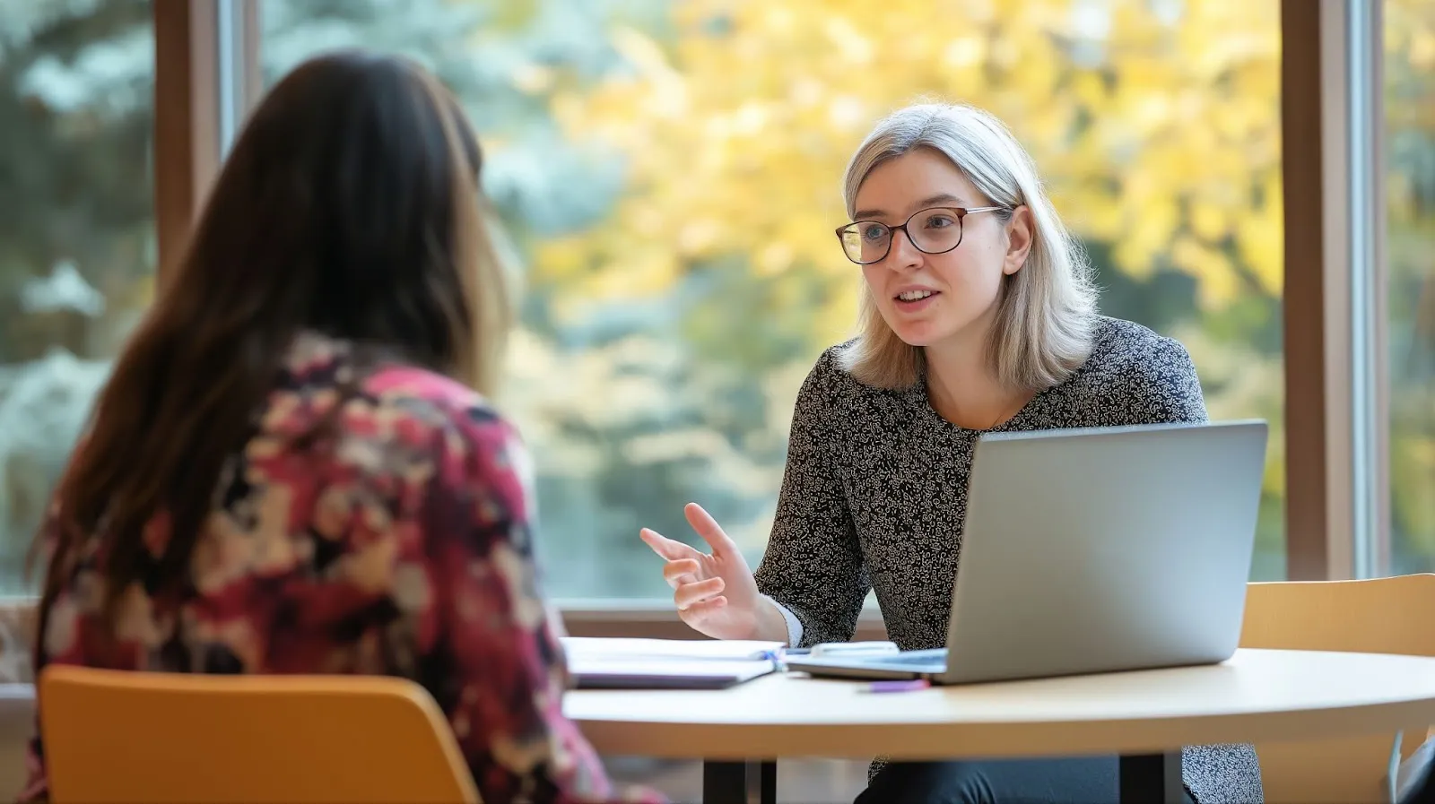 Two teachers meet at a coffee shop for their PLC.