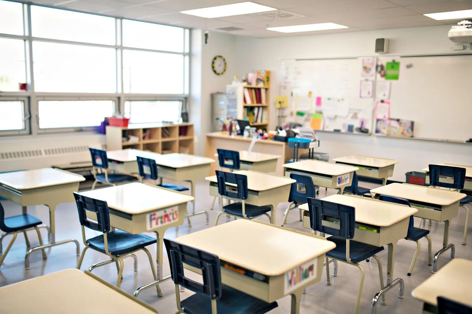 A sparse classroom with large windows. No students are pictured.