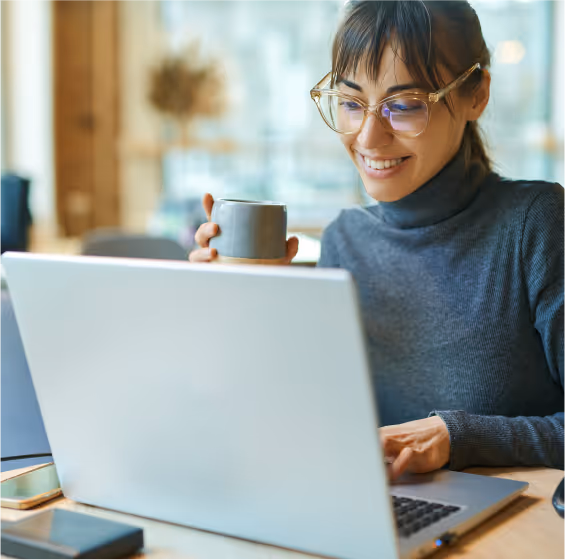 A smiling woman using a laptop
