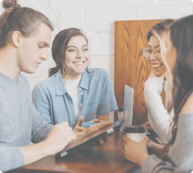 A group of smiling young professionals and partners having a meeting