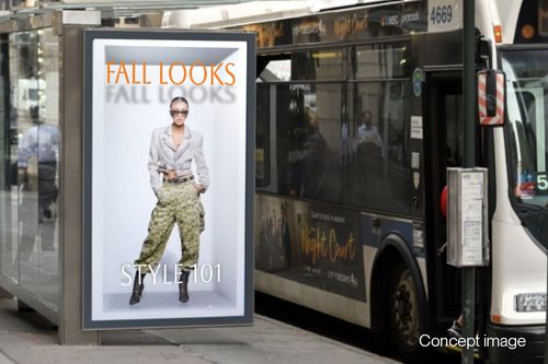 Bus shelter advertising on a large Hololuminescent™ Display (HLD) with a fashion campaign titled 'FALL LOOKS STYLE 101' featuring a woman in a gray cropped jacket, patterned pants, and sunglasses.