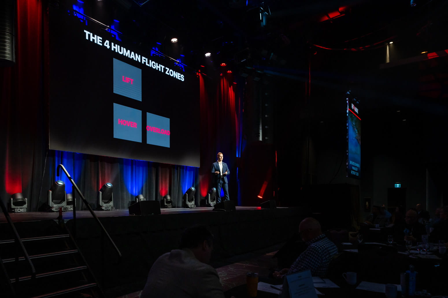 Speaker Chris Wilson giving a TEDx talk to a live audience.