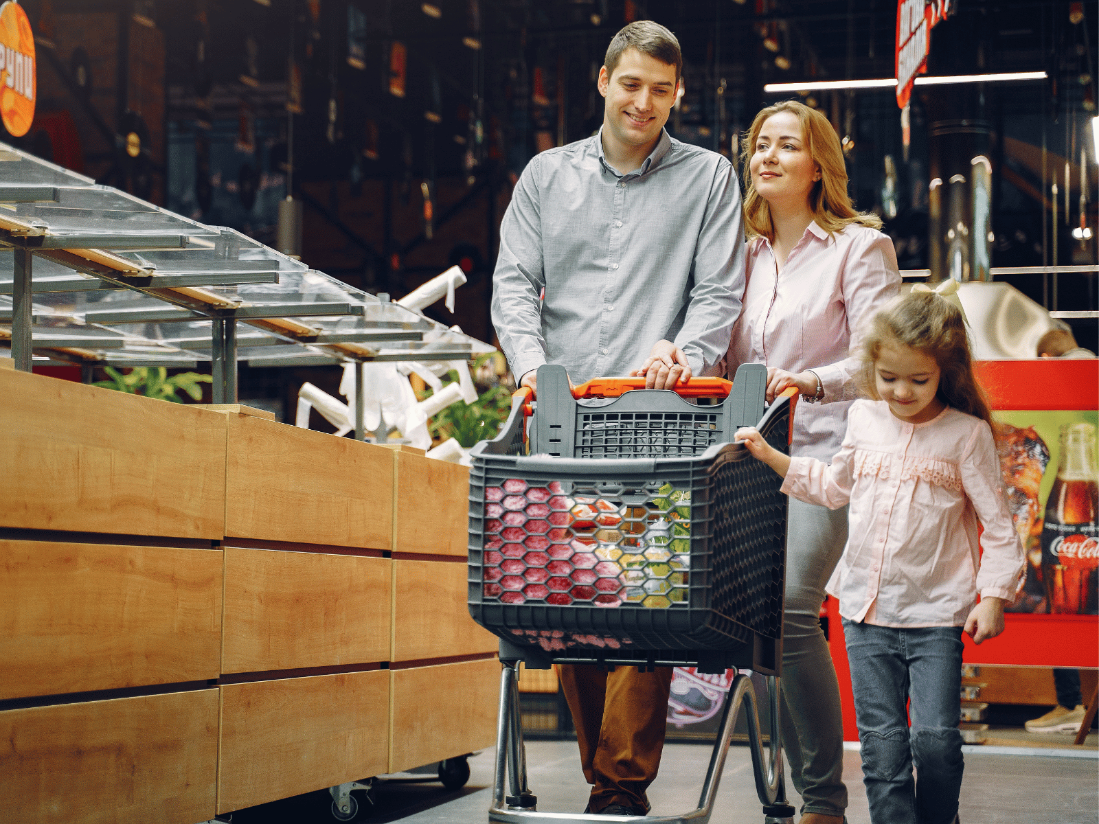 Family walking with cart through a supermarket