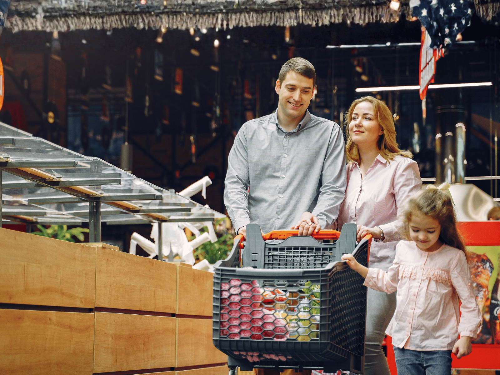 Family walking with cart through a supermarket