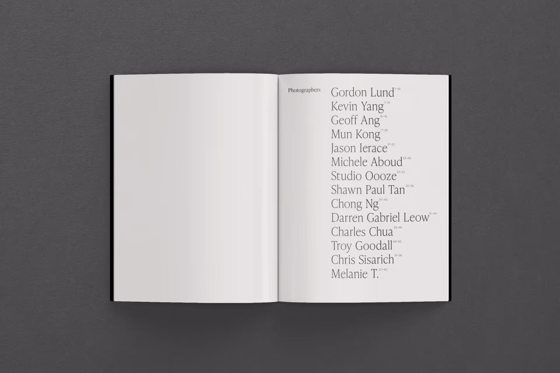 Open book on a dark surface listing photographers' names in a clean serif font on the right page.