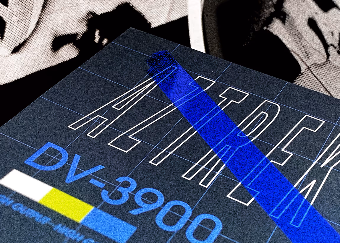 Close-up of a printed sheet showing the word 'ALDREN' in outlined letters with a blue diagonal stripe and text 'DV-3900' below it.