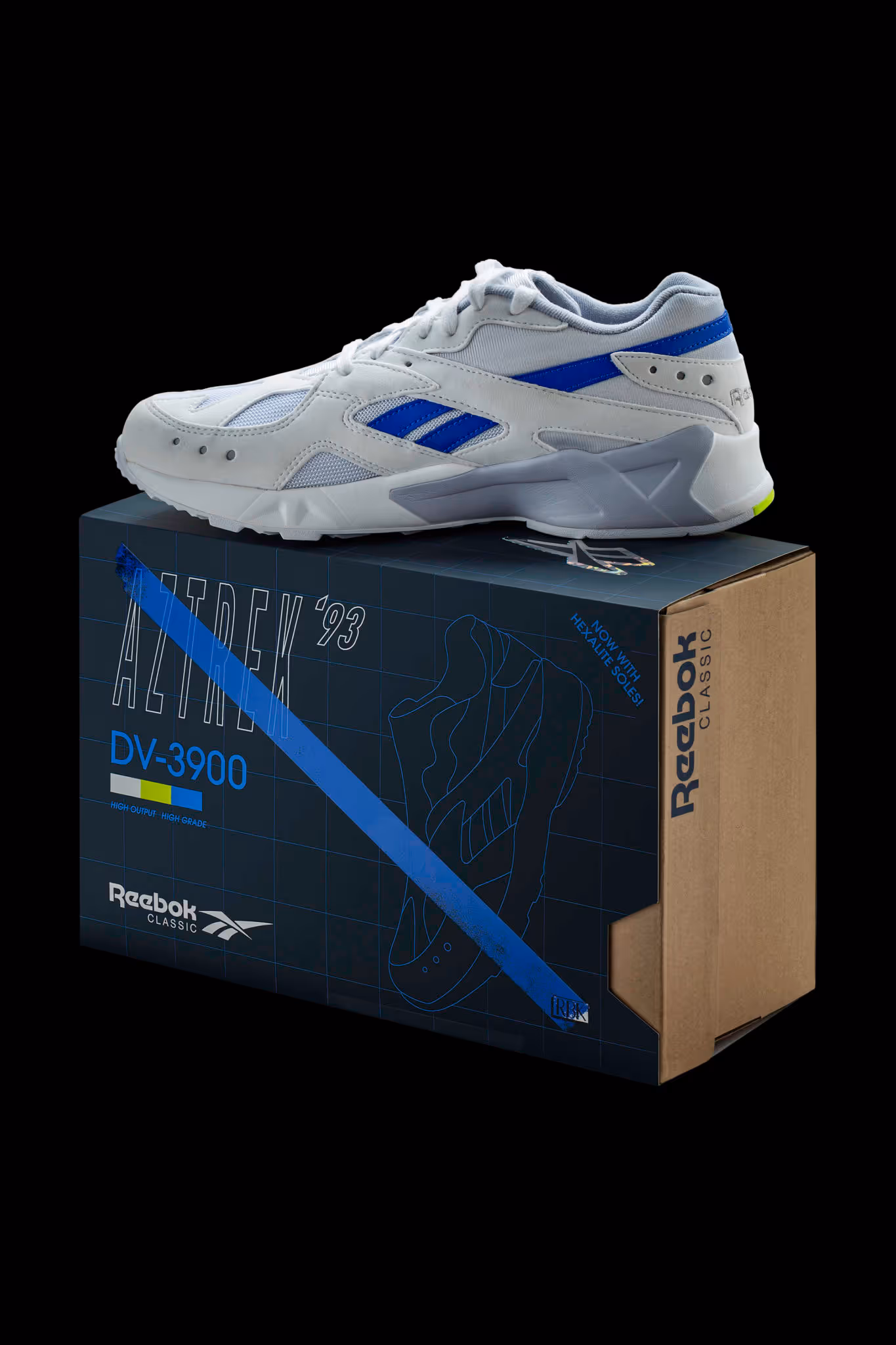 White and blue Reebok Aztrek '93 sneaker displayed on its black and brown Reebok Classic shoe box.