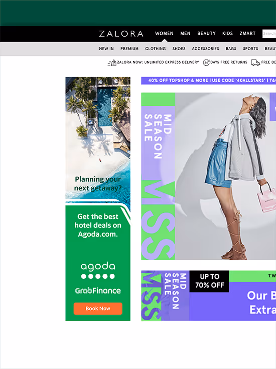 Zalora website showing mid-season sale advertisement with a woman posing in blue skirt and gray jacket, and side ad for Agoda hotel deals.