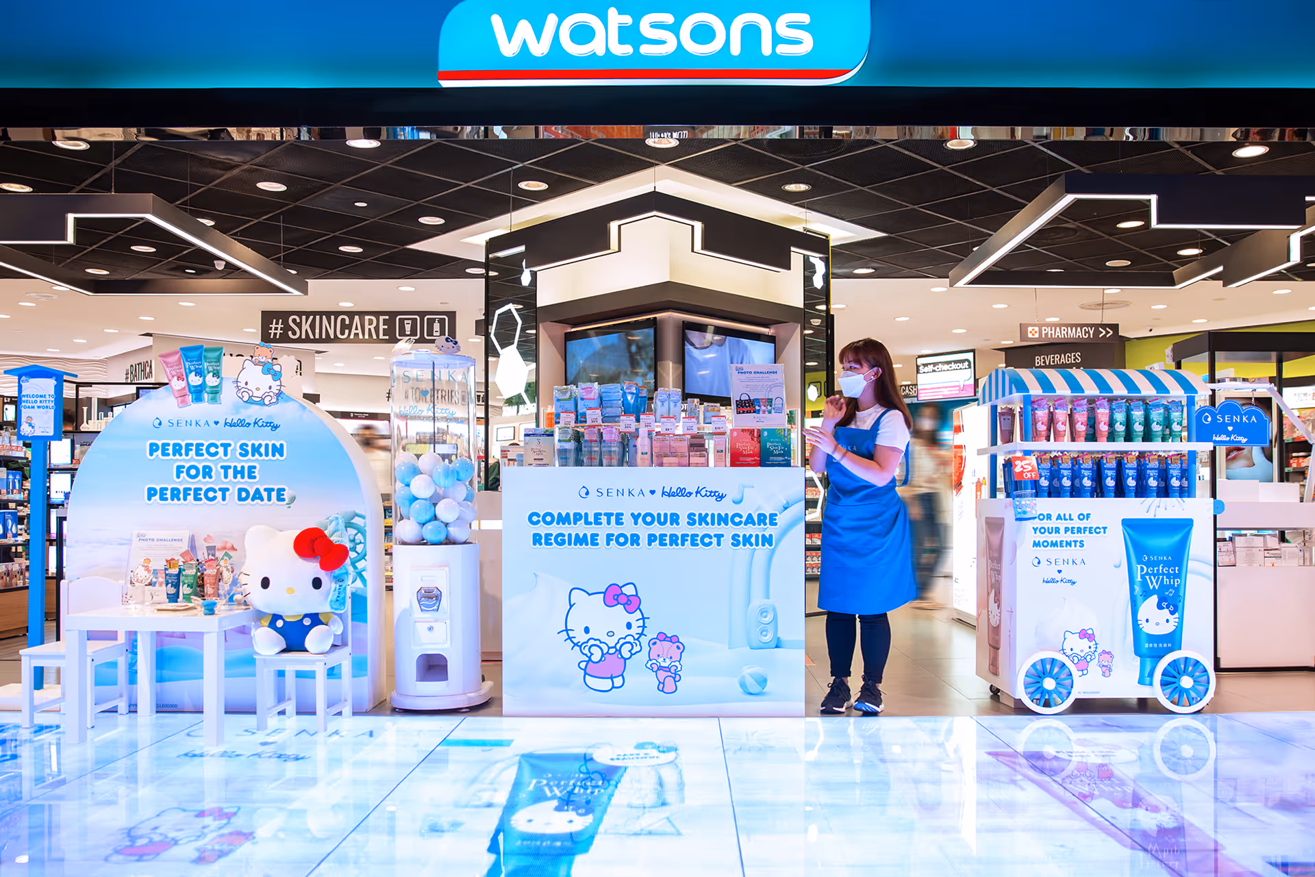 Watsons store skincare display featuring Senka x Hello Kitty products with a staff member in blue apron and face mask.