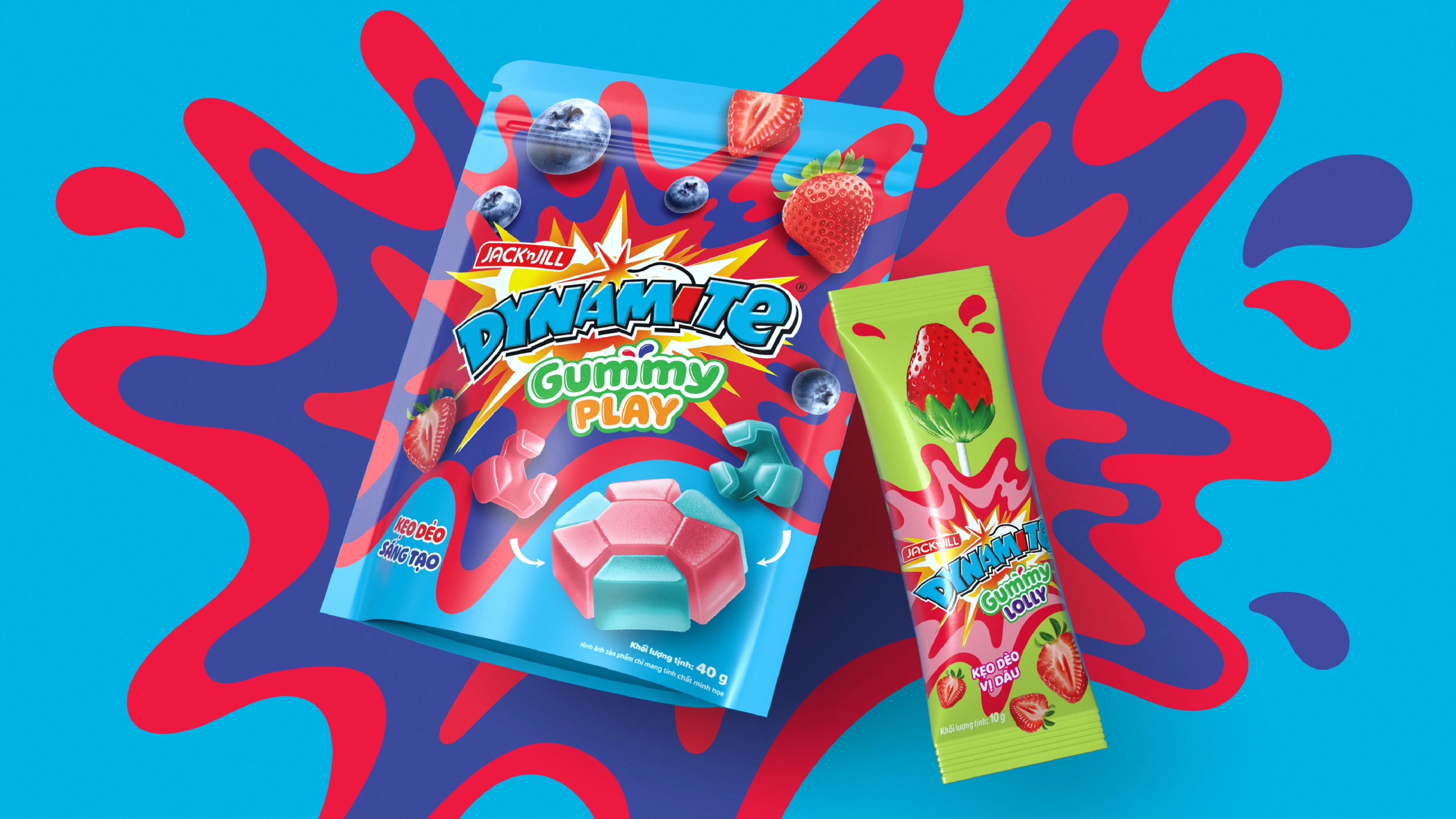 Colorful Dynamite Gummy Play and Gummy Lolly candy packaging with blueberries and strawberries on a blue and red abstract background.