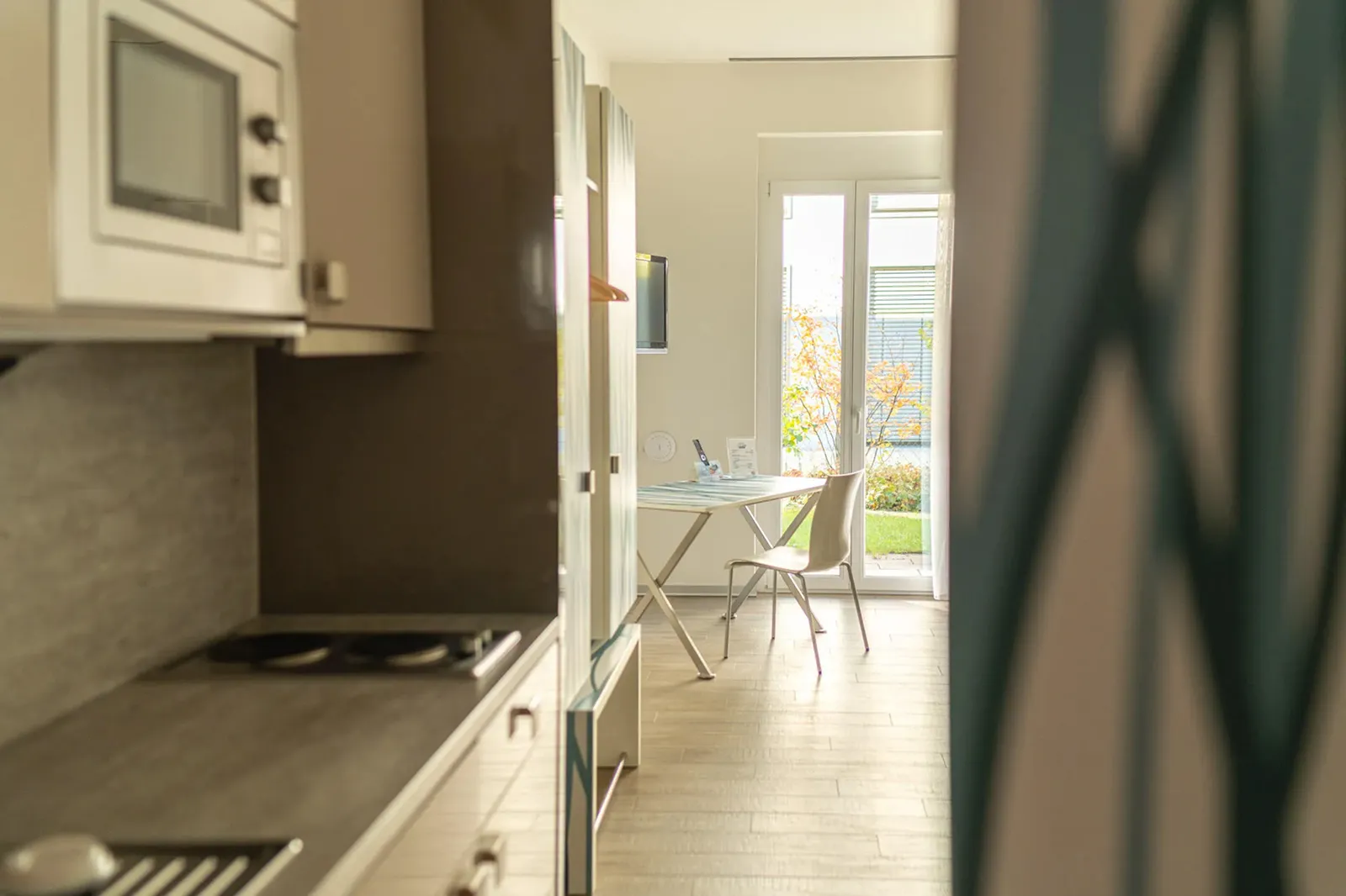 A kitchen with a table and chairs in it.